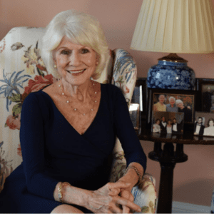 Diane Rehm sits in her home next to a photo of her with her husband John